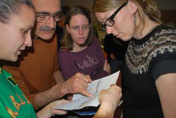 Scientist grouped around map of Haiti earthquake