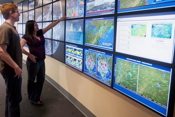Students study the weather wall at Penn State
