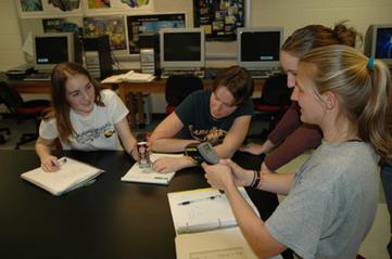 students measuring temperature of compressed gas as it is released from can
